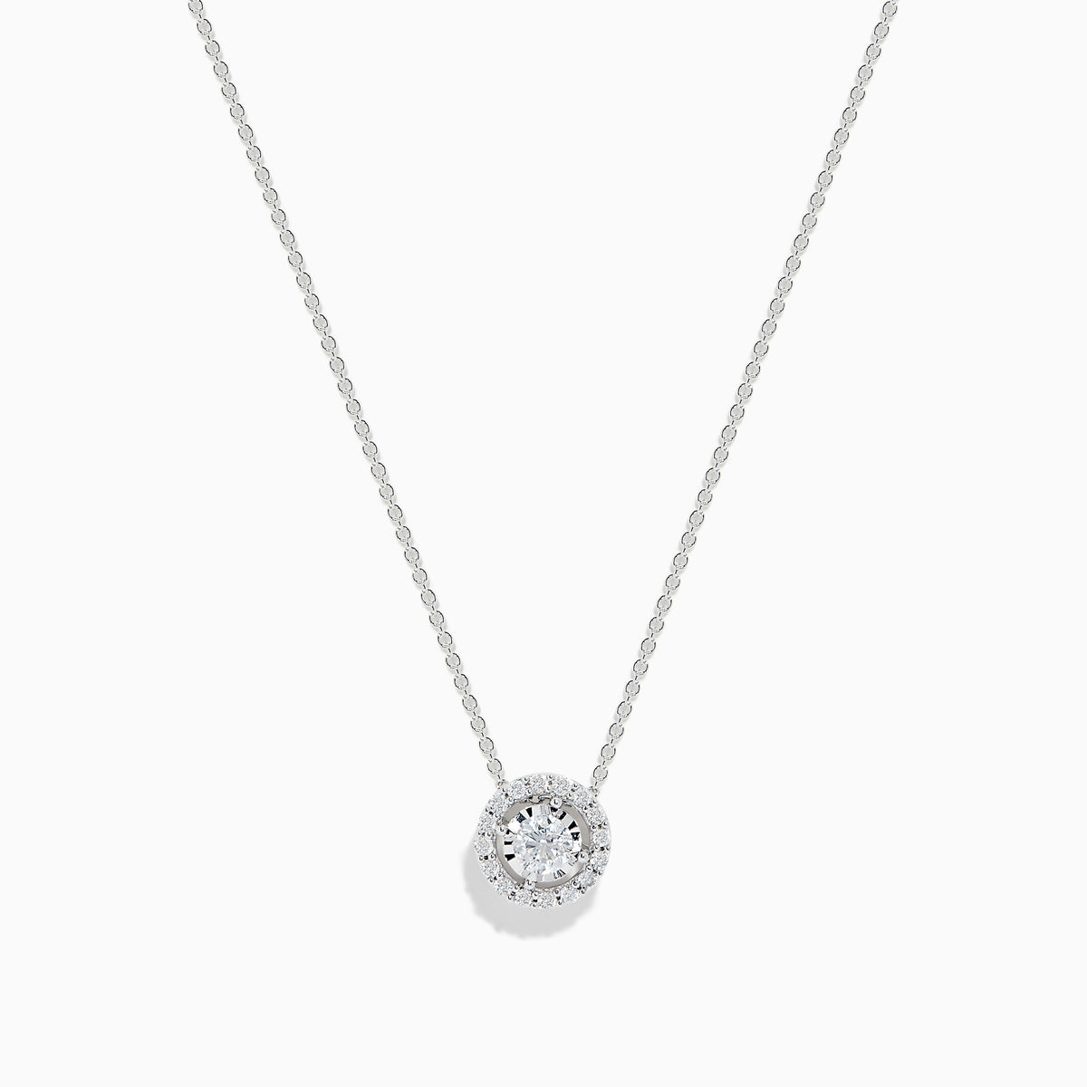 The Pave Classica 14K White Gold Diamond Pendant (0.49 TCW) by Effy features a brilliant round diamond surrounded by a halo of smaller diamonds, elegantly set on a simple white gold chain and showcased against a white background.