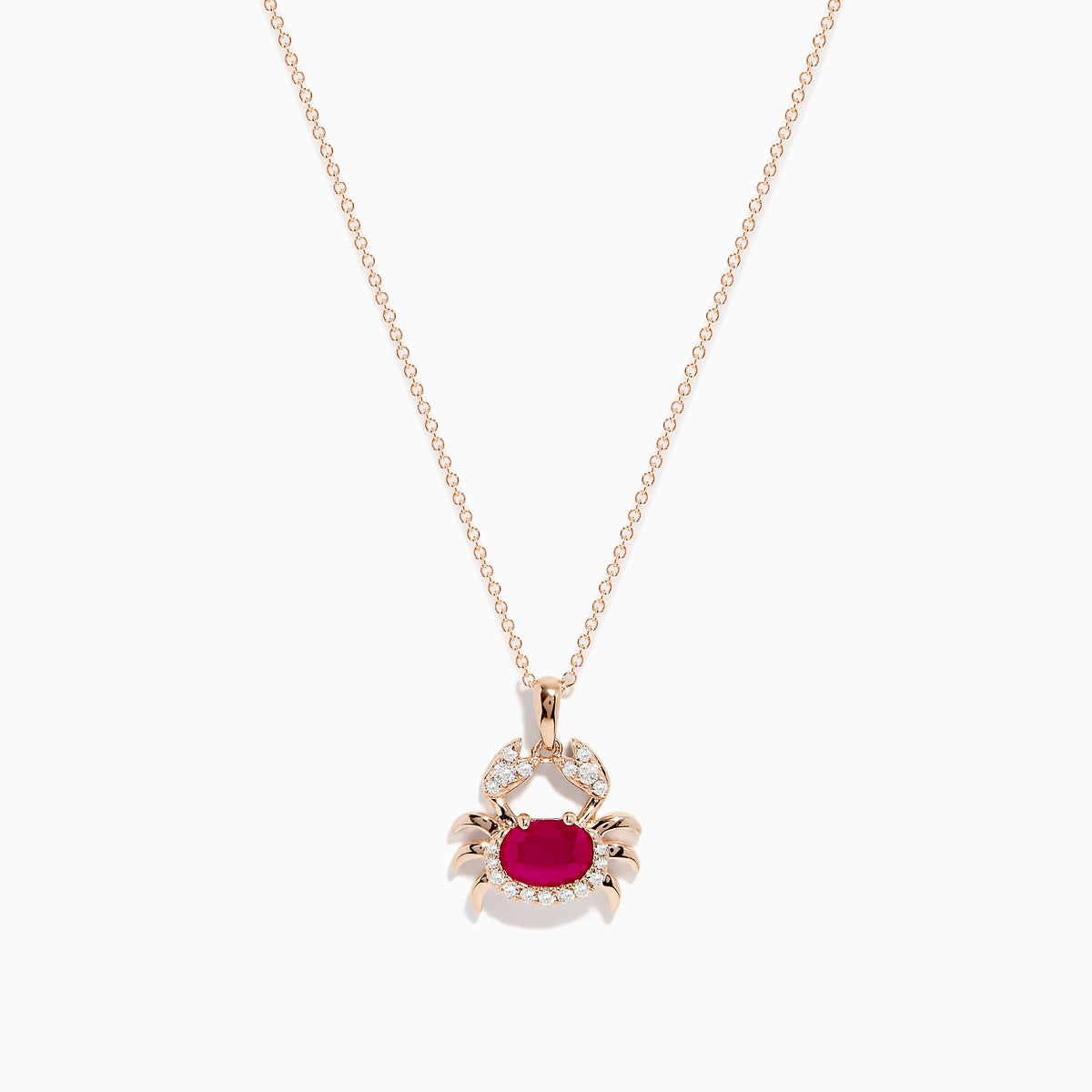 The Seaside 14K Rose Gold Ruby and Diamond Crab Pendant features a ruby-red oval gemstone body and sparkling white stones outlining the crab’s claws and shell, all on a delicate rose gold necklace.
