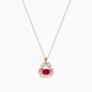 The Seaside 14K Rose Gold Ruby and Diamond Crab Pendant features a ruby-red oval gemstone body and sparkling white stones outlining the crab’s claws and shell, all on a delicate rose gold necklace.