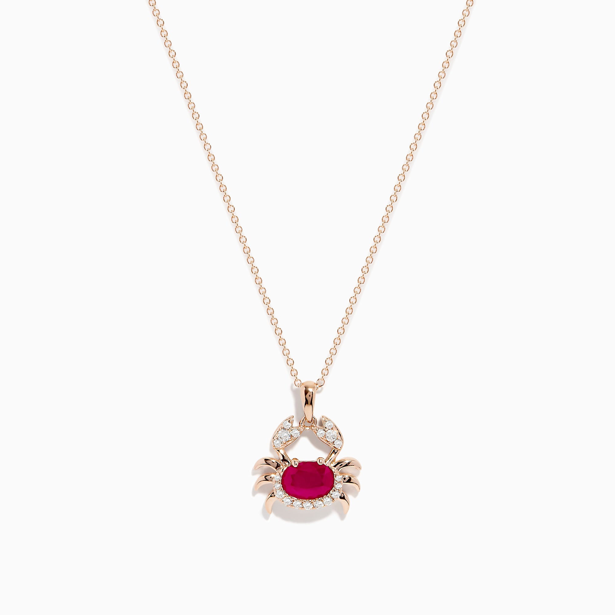 The Seaside 14K Rose Gold Ruby and Diamond Crab Pendant features a ruby-red oval gemstone body and sparkling white stones outlining the crab’s claws and shell, all on a delicate rose gold necklace.