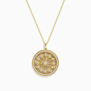 The DOro 14K Yellow Gold Diamond Mandala Pendant features a circular design with an intricate, symmetrical floral pattern set with sparkling white diamonds.