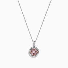 The 14K Two Tone Gold Pink and White Diamond Pendant (0.54 TCW) combines pink center stones with a double halo of sparkling diamonds for an elegant, eye-catching look reminiscent of a classic diamond pendant.
