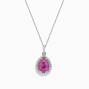 The 14K Two Tone Gold Pink Sapphire and Diamond Pendant, 1.74 TCW, features a pear-shaped pink sapphire surrounded by clear and yellow stones in a halo design, blending diamond-like elegance with stylish two-tone gold accents.