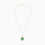 The Brasilica 14K Yellow Gold Emerald and Diamond Pendant features a flower-inspired design with emerald petals, diamond accents, and a fine gold chain.