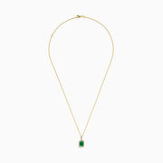 The 14K Yellow Gold Diamond and Emerald Pendant showcases a rectangular green emerald set in yellow gold, accented by small clear diamonds.