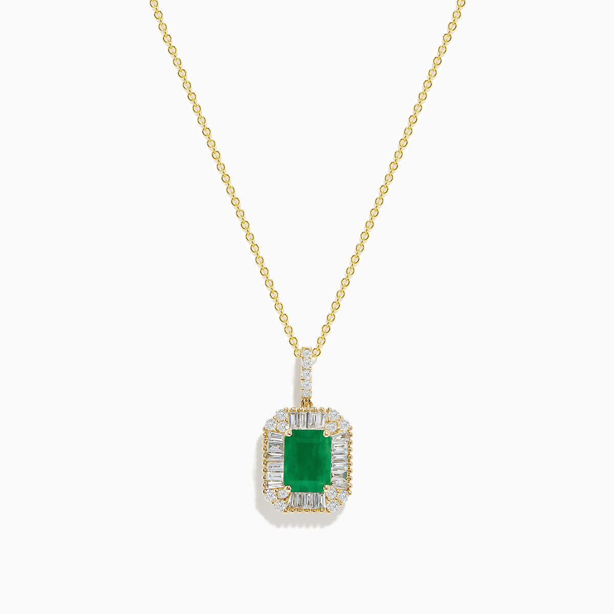 The 14K Yellow Gold Baguette Diamond Halo Emerald Pendant features a rectangular emerald framed by baguette and round diamonds, set in yellow gold with a decorative border, displayed against a white background.