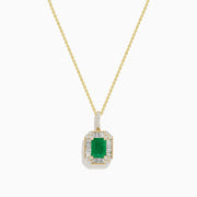 The 14K Yellow Gold Baguette Diamond Halo Emerald Pendant features a rectangular emerald framed by baguette and round diamonds, set in yellow gold with a decorative border, displayed against a white background.
