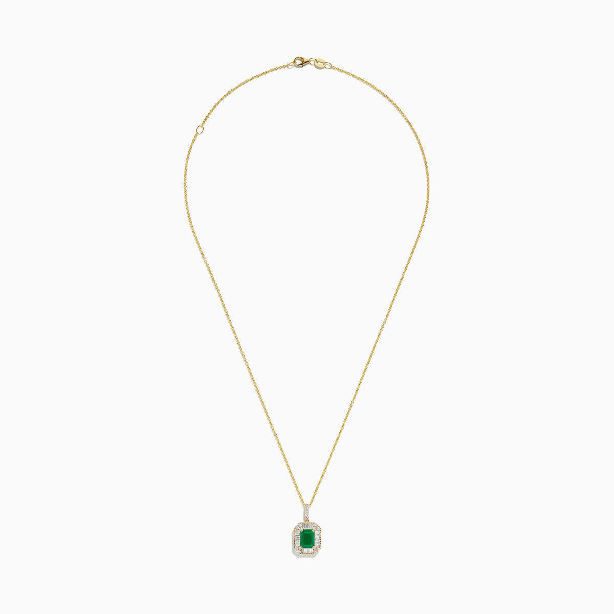 The 14K Yellow Gold Baguette Diamond Halo Emerald Pendant features a rectangular emerald framed by baguette and round diamonds, set in yellow gold with a decorative border, displayed against a white background.
