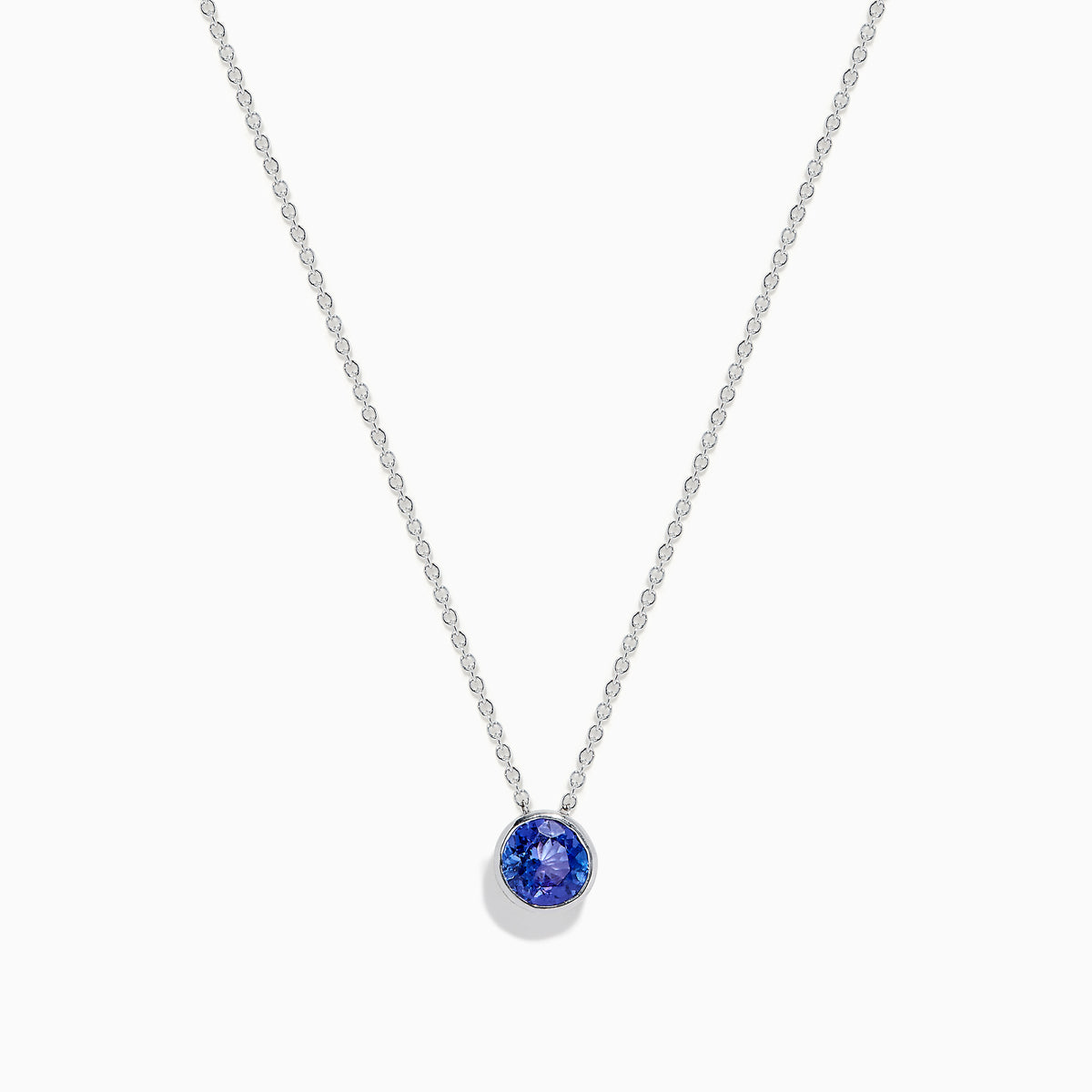The 925 Sterling Silver Tanzanite Pendant features a delicate sterling silver chain with a tanzanite stone in a simple bezel setting, shown on a white background.
