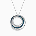 The Bella Bleu 14K White Gold Blue and White Diamond Pendant (0.98 TCW) showcases interlocking circles—one with blue diamonds, one with white—suspended from a delicate white gold chain against a white background.