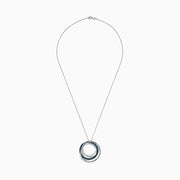 The Bella Bleu 14K White Gold Blue and White Diamond Pendant (0.98 TCW) showcases interlocking circles—one with blue diamonds, one with white—suspended from a delicate white gold chain against a white background.