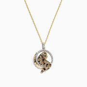 A Signature 14K yellow gold panther pendant, accented with multi-color diamonds (0.81 TCW), displays a sparkling green tsavorite eye and sits in a radiant circular frame.