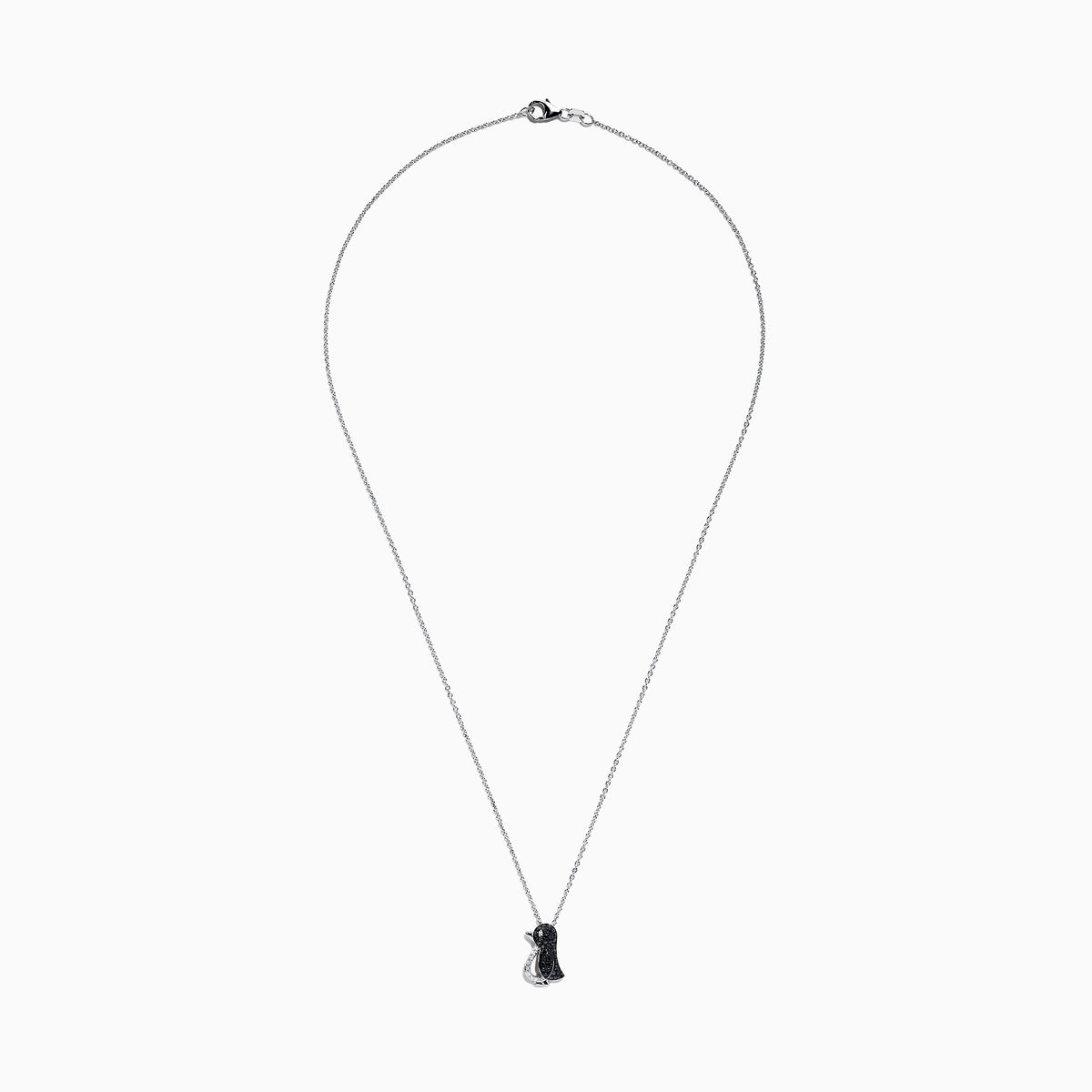 The Safari Sterling Silver Black and White Diamond Penguin Pendant (0.31 TCW) hangs from a delicate chain, its playful penguin design dazzling with black and white diamonds set in sterling silver against a white background.