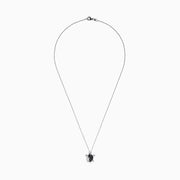 Introducing the Seaside Sterling Silver Black and White Diamond Turtle Pendant, 0.32 TCW—a stunning necklace featuring a turtle-shaped charm adorned with sparkling black and white diamond accents. A delicate silver baby turtle charm gracefully hangs from its side, adding a unique touch to this elegant design.