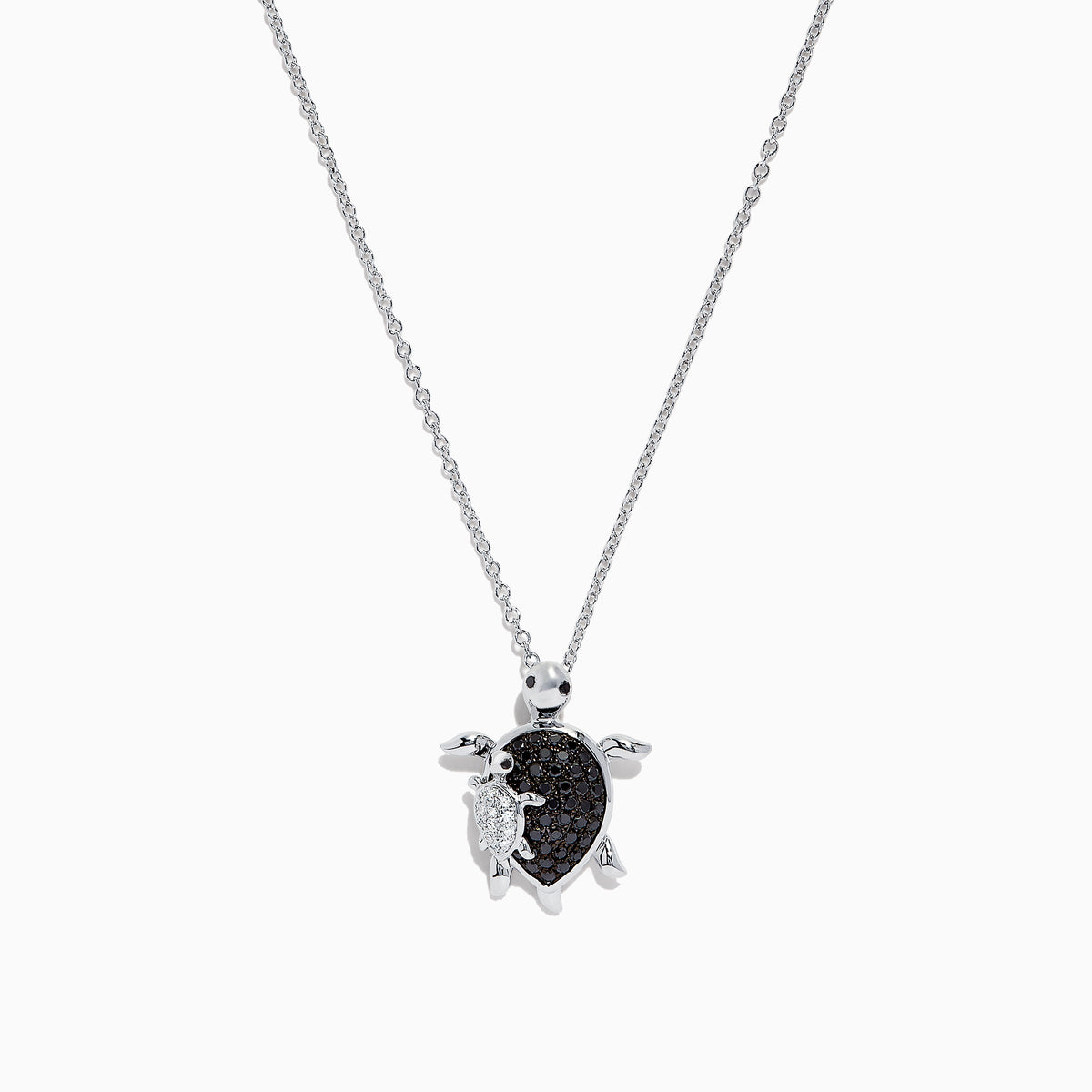Introducing the Seaside Sterling Silver Black and White Diamond Turtle Pendant, 0.32 TCW—a stunning necklace featuring a turtle-shaped charm adorned with sparkling black and white diamond accents. A delicate silver baby turtle charm gracefully hangs from its side, adding a unique touch to this elegant design.