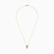 The Signature 14K Yellow Gold Diamond and Emerald Pendant features a panther’s head with diamond accents, emerald eyes, black detailing for spots, and a circular ring held in its mouth.