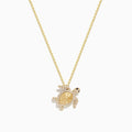 Seaside 14K yellow gold turtle pendant adorned with white and black diamonds, shown on a plain white background.