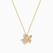 Seaside 14K yellow gold turtle pendant adorned with white and black diamonds, shown on a plain white background.