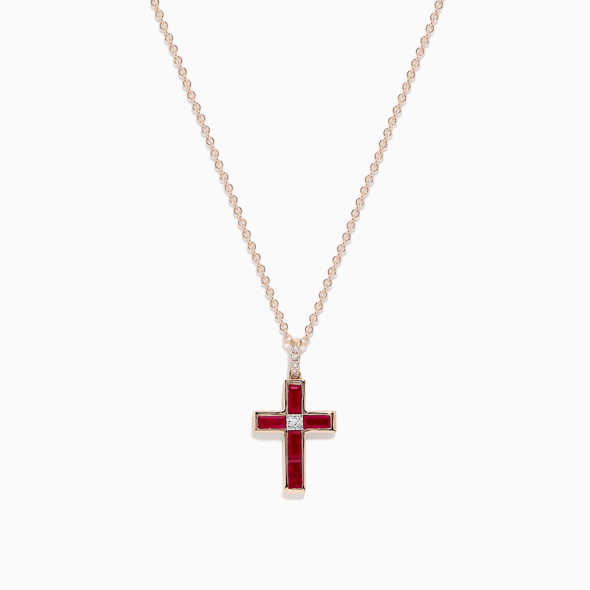 The Ruby Royale 14K Rose Gold Ruby and Diamond Cross Pendant, featuring a small clear center stone, is displayed on a rose gold chain against a white background.