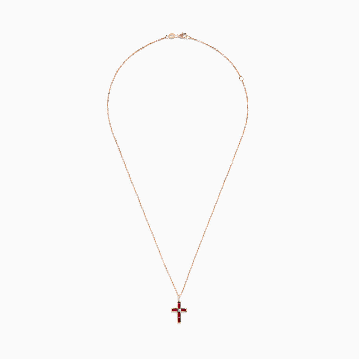 The Ruby Royale 14K Rose Gold Ruby and Diamond Cross Pendant, featuring a small clear center stone, is displayed on a rose gold chain against a white background.