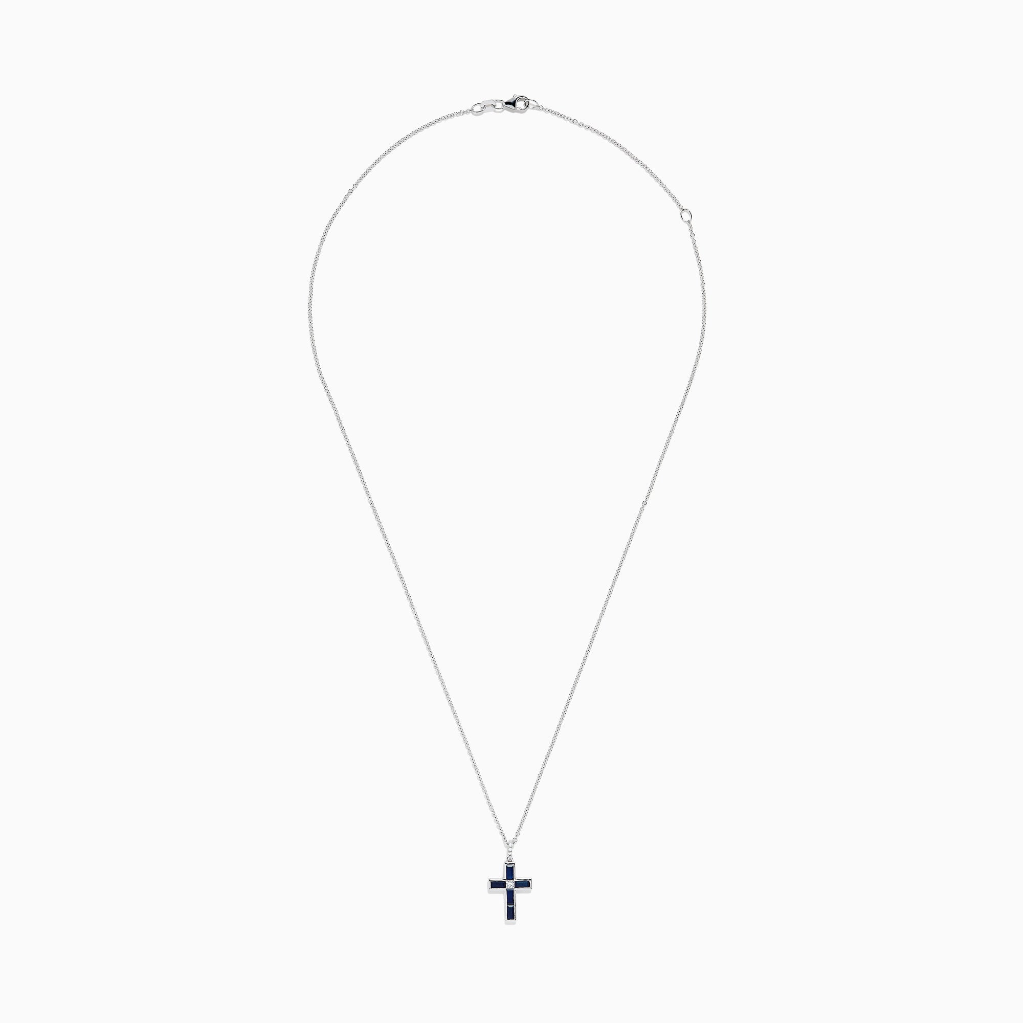 The Royale Bleu 14K White Gold Sapphire and Diamond Cross Pendant features a silver chain and striking dark blue sapphire-like rectangular stones, displayed on a plain white background.