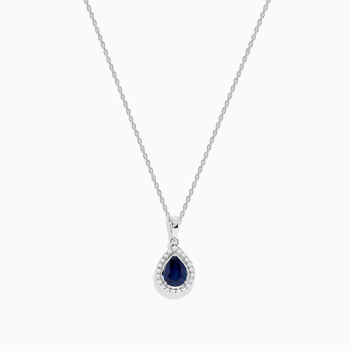 The Royale Bleu 14K White Gold Sapphire and Diamond Pendant features a teardrop sapphire encircled by shimmering diamonds, elegantly displayed on a white background.