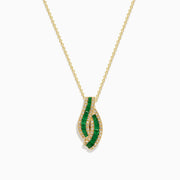 The 14K Yellow Gold Emerald and Diamond Pendant features a teardrop-shaped emerald design, highlighted by two curved rows of sparkling diamonds that outline its shape.