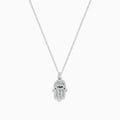 The Novelty 14K White Gold Black and White Diamond Hamsa Pendant features a sparkling eye-design centerpiece on a dainty white gold chain, showcased against a white background.