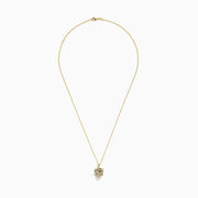 The Signature 14K Yellow Gold Black and White Diamond Panther Pendant is a chain necklace with a stylized panther design, featuring black and white diamonds and green gemstones, displayed against a white background.