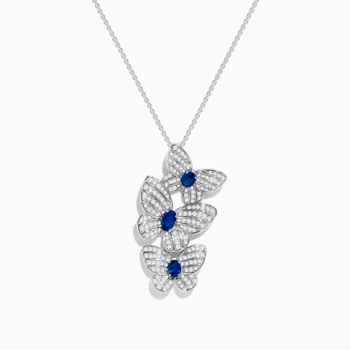 The 14K White Gold Blue Sapphire and Diamond Multi Butterfly Pendant features three butterflies accented with diamond-like stones and a central blue sapphire, hanging elegantly from a delicate chain.
