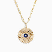 The Novelty 14K Yellow Gold Sapphire and Diamond Evil Eye Disk Pendant features a sunburst design with a sapphire center, diamond accents, gold spikes, and elongated oval chain links.