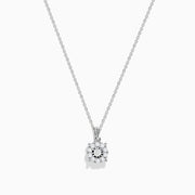 The 14K White Gold Diamond Pendant features a delicate chain and a dazzling diamond centerpiece surrounded by a halo of smaller diamonds, shown on a plain white background.