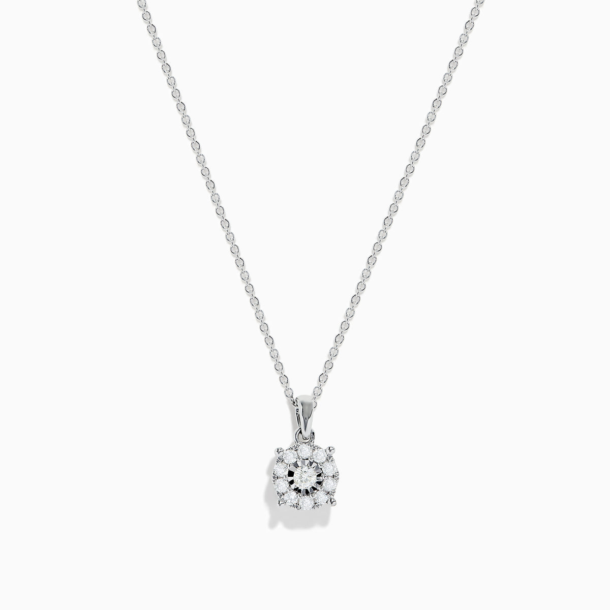 The 14K White Gold Diamond Pendant features a delicate chain and a dazzling diamond centerpiece surrounded by a halo of smaller diamonds, shown on a plain white background.