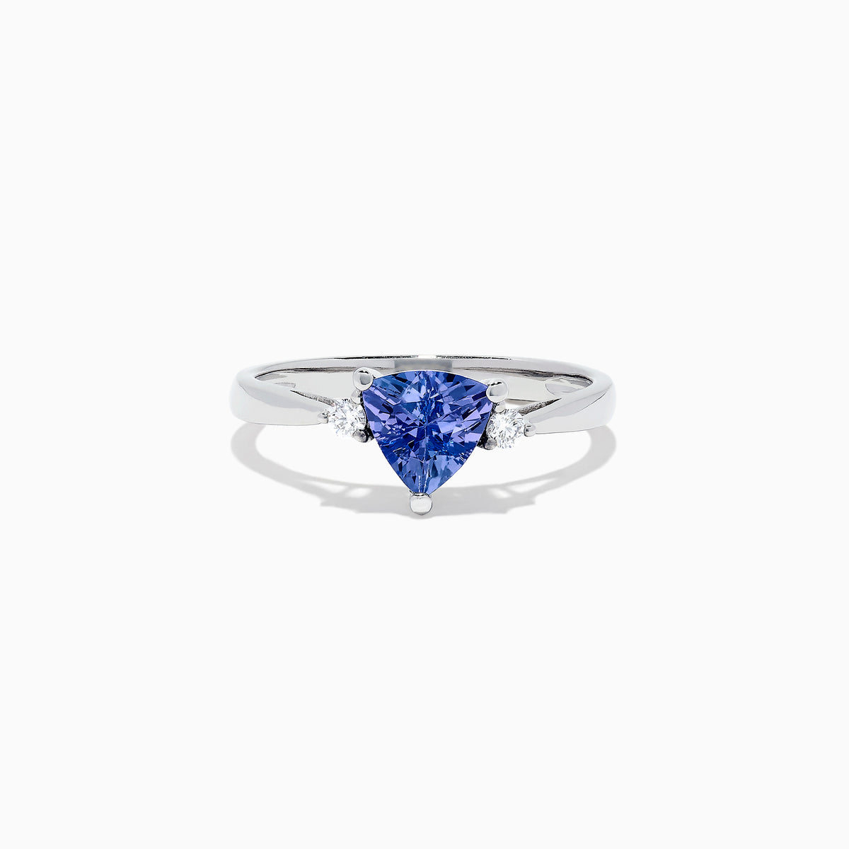 The Nahla Siri 14K White Gold Trillion Tanzanite and Diamond Ring, 1.07 TCW, features a triangular-cut tanzanite center accented by two round diamonds, shown on a white background.