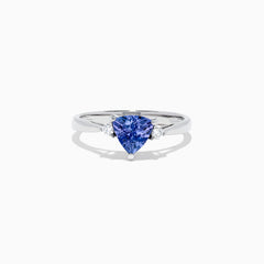 The Nahla Siri 14K White Gold Trillion Tanzanite and Diamond Ring, 1.07 TCW, features a triangular-cut tanzanite center accented by two round diamonds, shown on a white background.