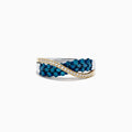 The 14K Two Tone Gold Blue and White Diamond Crossover Ring, 1.00 TCW, features a twisted silver design with yellow gold accents and sparkling rows of blue and white diamonds for a striking look.
