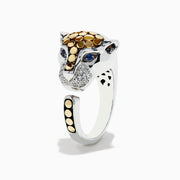 The 925 Sterling Silver & 18K Gold Diamond Panther Ring, 1.10 TCW, features a panther head with gold spots, blue gemstone eyes, and pavé-set clear stones on the snout. Its open band is accented with 18K gold spots on one end.