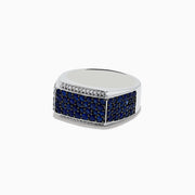 The Mens 925 Sterling Silver Diamond and Blue Sapphire Ring features a wide band with a rectangular blue sapphire section bordered by small diamonds in a geometric pattern.