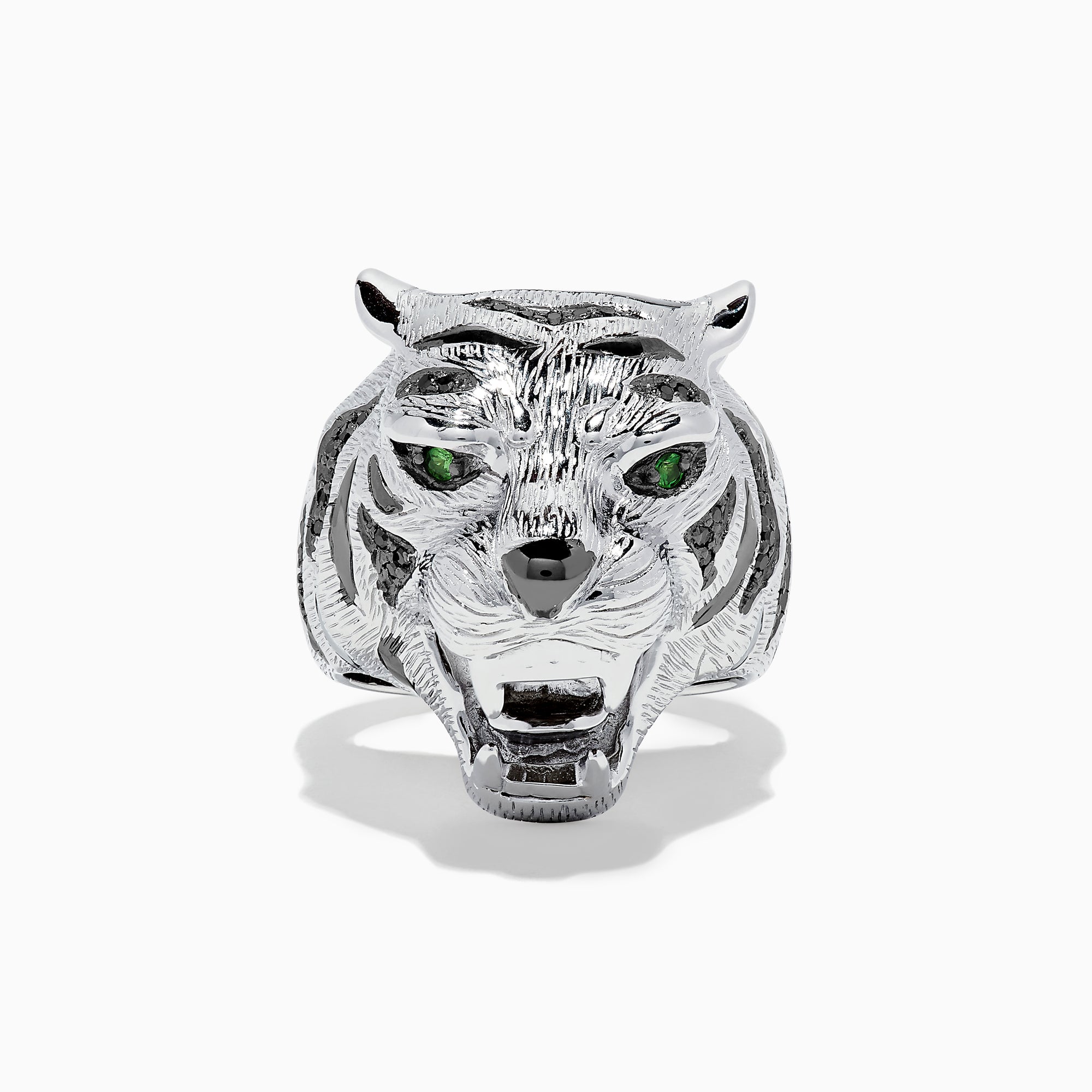 The Sterling Silver Black Diamond and Tsavorite Tiger Ring, 0.21 TCW, features a tiger’s head design with detailed fur, black diamonds, and vivid green Tsavorite eyes, displayed against a white background.