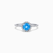The Ocean Bleu 14K White Gold Blue Topaz and Diamond Ring, 1.12 TCW, showcases a round blue topaz center with a diamond halo and diamonds on the band.
