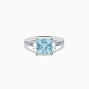 The Aquarius 14K White Gold Diamond and Aquamarine Ring showcases a square light blue aquamarine center, two rectangular clear side stones, and sparkling white diamond accents along the band.