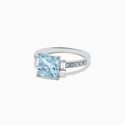The Aquarius 14K White Gold Diamond and Aquamarine Ring showcases a square light blue aquamarine center, two rectangular clear side stones, and sparkling white diamond accents along the band.
