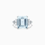 The Aquarius 14K White Gold Aquamarine and Diamond Ring, 5.05 TCW, features a bold emerald-cut aquamarine center with rectangular and round diamond accents on each side, displayed against a plain white background.