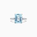 The Aquarius 14K White Gold Aquamarine and Diamond Ring, 4.12 TCW, features a large emerald-cut aquamarine with sparkling round diamonds on the band, shown against a plain white background.