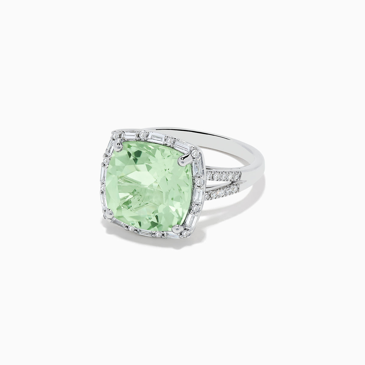 The 14K White Gold Green Amethyst and Diamond Ring showcases a cushion-cut green amethyst center, accented by a halo of clear baguette and round diamonds, all set in white gold.