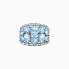 The Aquarius 14k White Gold Aquamarine and Diamond Ring showcases a wide band set with nine oval-cut aquamarines in three rows, accented by sparkling diamonds along the edges for added brilliance.