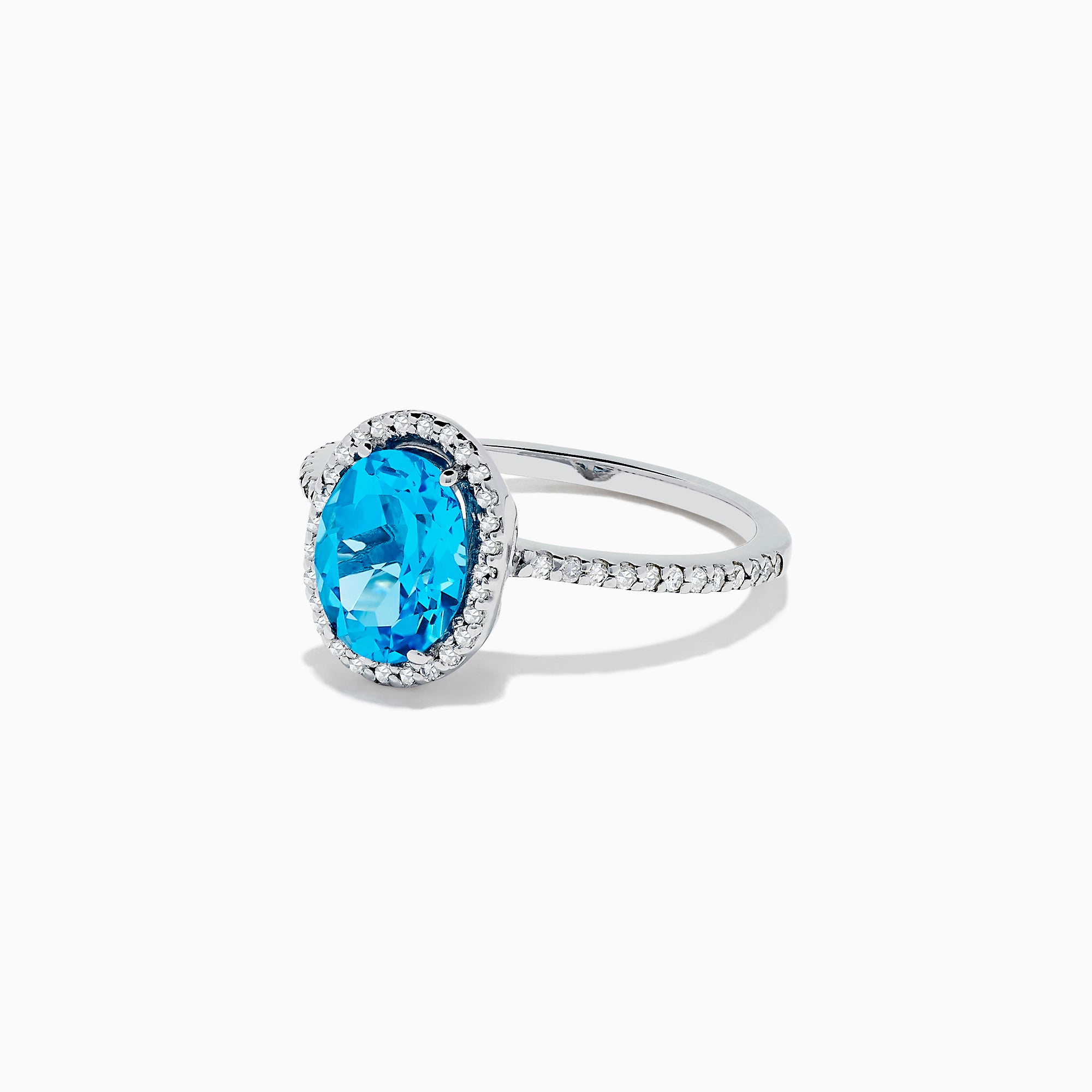 The Ocean Bleu 14K White Gold Blue Topaz and Diamond Ring, 2.51 TCW, showcases an oval blue topaz center with a diamond halo and additional diamonds along the band.