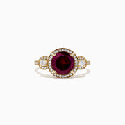 The Bordeaux 14K Yellow Gold Rhodolite Garnet and Diamond Ring (2.14 TCW) features a round rhodolite garnet center, haloed by white diamonds, with diamond accents along the band and two diamond clusters on each side.