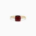 The Bordeaux 14K Yellow Gold Garnet and Diamond Ring (1.66 TCW) features a cushion-cut deep red garnet centerpiece with round white diamonds set along the band.