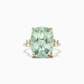 The 14K Yellow Gold Green Amethyst and Diamond Cocktail Ring (10.51 TCW) showcases a striking rectangular green amethyst center, accented by small diamonds on each side, set against a white background.